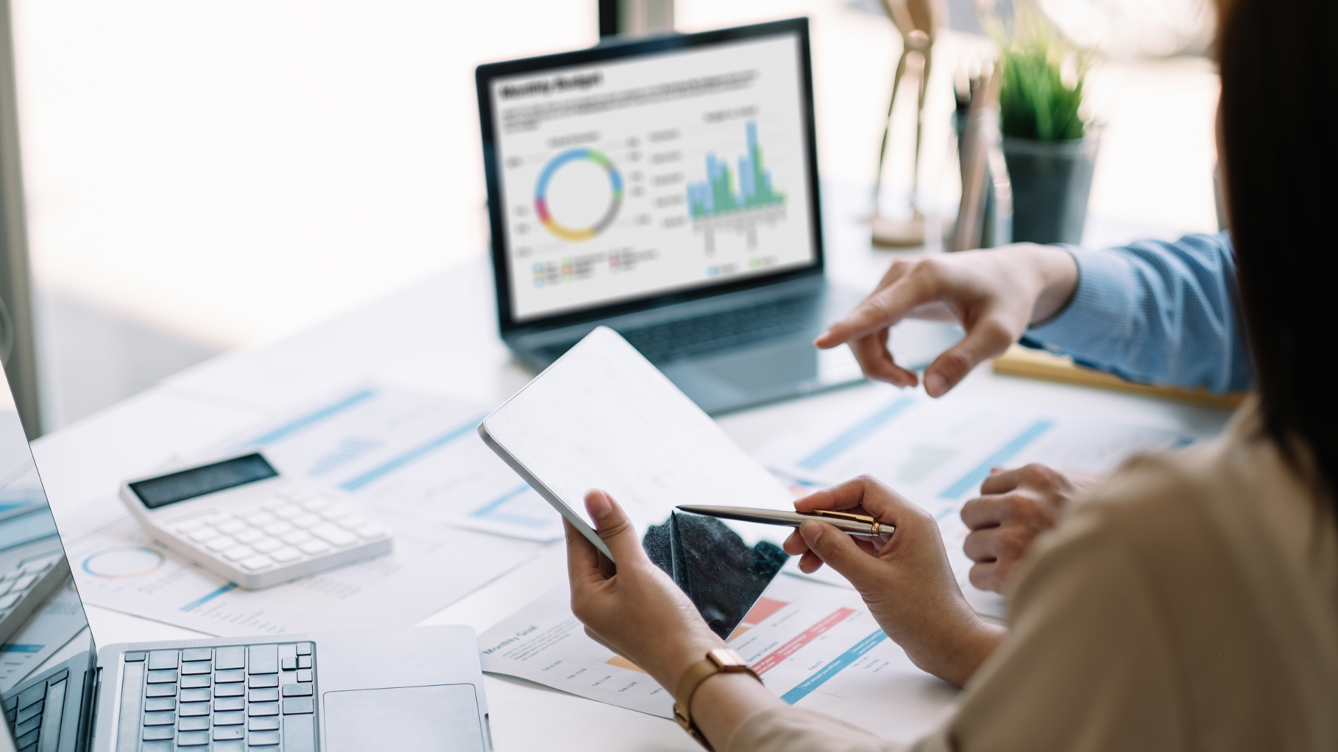 business meeting over graphs on a computer